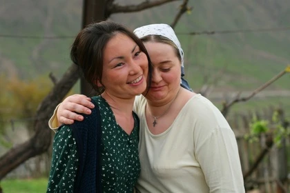 Two women hug warmly in "Song of the South Seas".