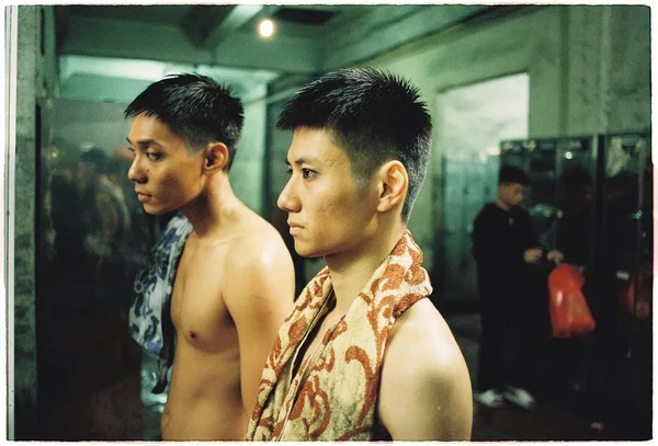 Two men with towels in a bathroom in "Viet and Nam